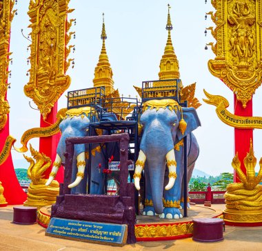 The statue of two elephants with golden adornments in Phra Chiang Saen Si Phaendin temple, Golden Triangle, Ban Sop Ruak, Thailand clipart