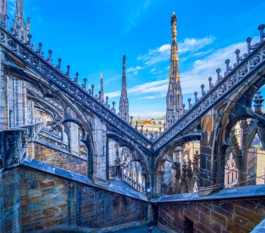 Stone Carved flying buttresses in Gothic style on the roof of Milan Cathedral, Italy clipart