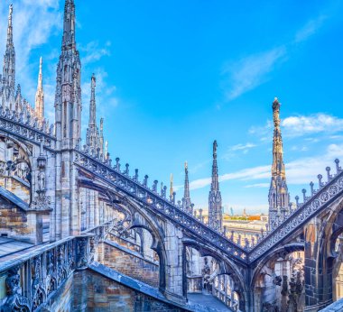 Stone Carved flying buttresses in Gothic style on the roof of Milan Cathedral, Italy clipart