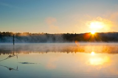 Sabahın erken saatlerinde Kuzey Makedonya 'nın Veles kentinde sislerin yükselmeye başladığı Mladost Gölü' nün üzerindeki buharlı gündoğumunu izleyin.