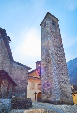 The small square of the old Prato Sornico village with Church of San Martino and its stone belfry, Val Lavizzara, Vallemaggia, Ticino, Switzerland clipart