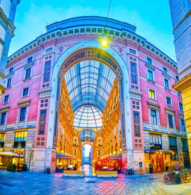 MILAN, ITALY - APRIL 11, 2022: Panoramic view on side entrance portal to Galleria Vittorio Emanuele II, on April 11 in Milan, Italy clipart