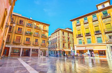 GRANADA, SPAIN - SEPTEMBER 27, 2019: Historical edifices, tourist cafes, stores and souvenir shops in Plaza de las Pasiegas square, on September 27 in Granada