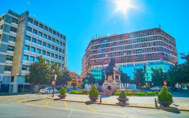 GRANADA, SPAIN - SEPTEMBER 25, 2019: The bronze statue of Catholic Monarchs (Reyes Catolicos) with fountain in front of modern building in Plaza Isabel la Catolica square, on September 25 in Granada clipart