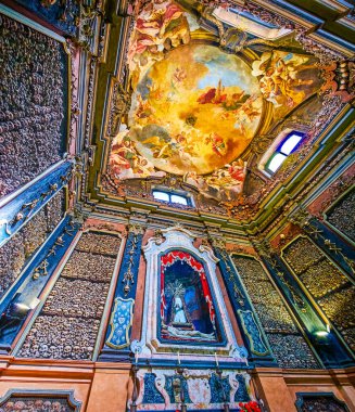 MILAN, ITALY - APRIL 11, 2022: The skulls in interior of San Bernardino alle Ossa Ossuary, on April 8 in Milan, Italy clipart