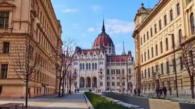 BUDAPEST, HUNGARY - 3 Mart 2022: Budapeşte, Macaristan Parlamento binası manzaralı Alkotmany Caddesi boyunca yürüyüş
