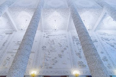 CHIANG, RAI, THAILAND - 10 Mayıs 2019: 10 Mayıs 'ta Chiang Rai' de Wat Huai Pla Kang kordinatındaki süslü tavan ve beyaz sütunların ayrıntılı görüntüsü