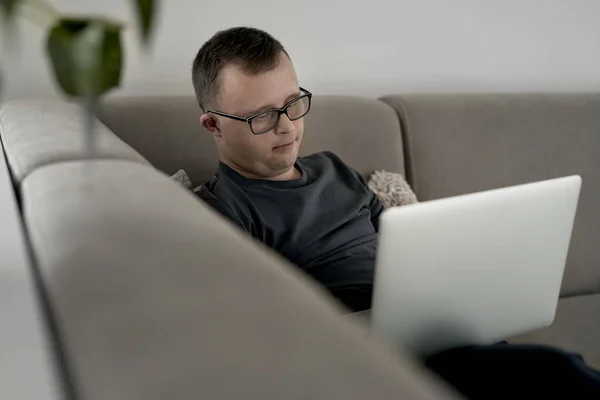 Homem Com Síndrome Usando Laptop Casa Enquanto Sentado Sofá — Fotografia de Stock