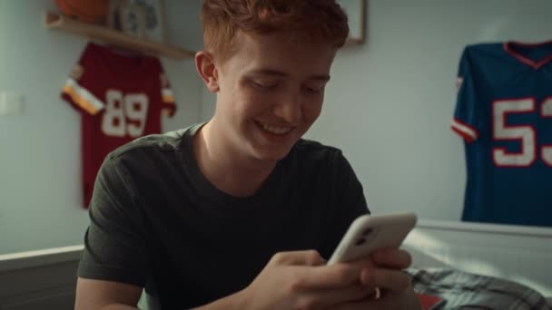 Close Caucasian Teenage Boy Browsing Phone While Sitting His Bedroom — Stock Video