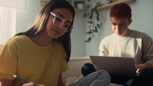 Two Caucasian Teenagers Sitting Bed Learning Books Laptop Together Shot — Stock Video
