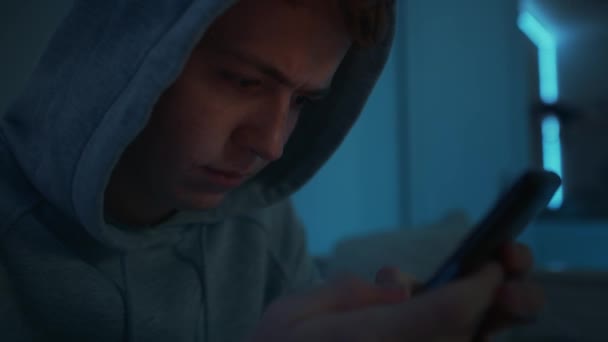 Focus Caucasian Teenage Boy Using Mobile Phone While Sitting Night — Stock Video