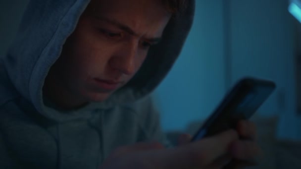 Focus Caucasian Teenage Boy Using Mobile Phone While Sitting Night — Stock Video