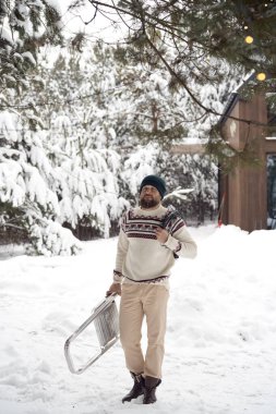 Caucasian man start decorating tree by Christmas light in winter season 