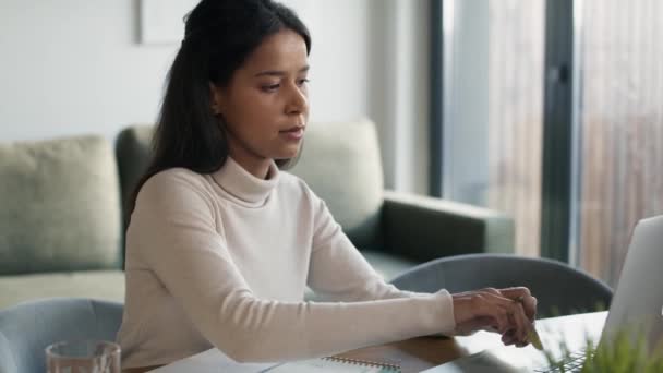 Mixed Race Woman Working Computer Making Notes Home Shot Red — Stockvideo