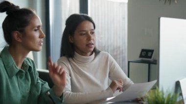 Two women working and analyzing something on computer at home. Shot with RED helium camera in 8K.     
