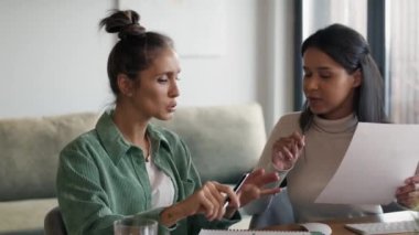 Two women working and analyzing something at home. Shot with RED helium camera in 8K.    