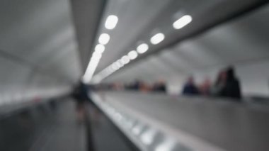 Blurred escalator  in the subway and unrecognizable people. Shot with Panasonic GH5   