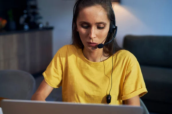 Caucasian woman working as call center at home