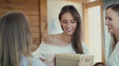 Group of caucasian women giving gifts to friend in pregnant. Shot with RED helium camera in 8K. 