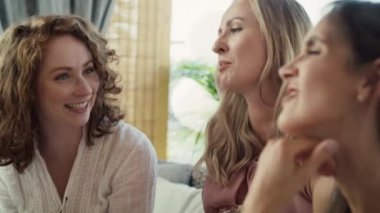 Group of smiling adult women at baby shower touching bell of pregnant woman. Shot with RED helium camera in 8K.   