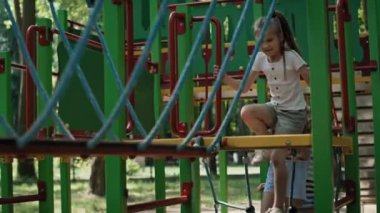 Group of girls playing at the playground in summer day. Shot with RED helium camera in 8K.  