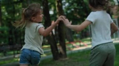 Caucasian girls running and playing at playground. Shot with RED helium camera in 8K.  