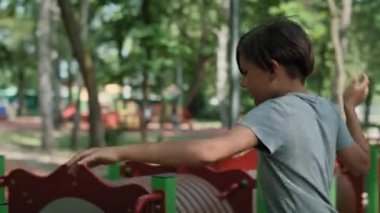 Two boys playing at the playground in summer day. Shot with RED helium camera in 8K.  