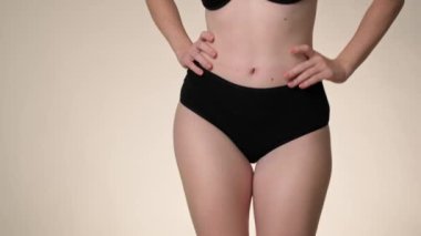 Unrecognizable woman in black underwear dancing in the studio. Shot with RED helium camera in 8K. 