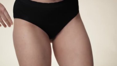 Unrecognizable woman in black underwear dancing in the studio. Shot with RED helium camera in 8K. 