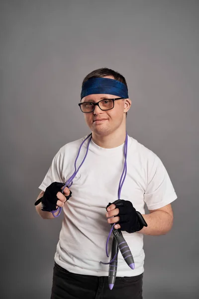 stock image Man with down syndrome with sporty clothes on gray background