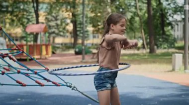 Caucasian girl playing with plastic hop at the playground. Shot with RED helium camera in 8K.  