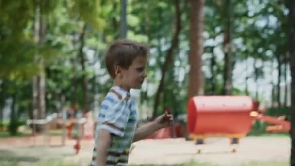 Caucasian Boy Running Playing Playground Shot Red Helium Camera — Stockvideo