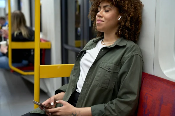 Young Afro Woman Traveling Underground Relaxing Mobile Phone Earphones — Stock Photo, Image