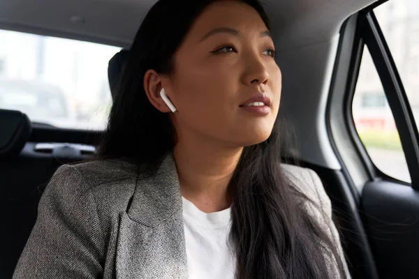 Zakelijk Chinese Vrouw Rijden Een Taxi Met Behulp Van Koptelefoon — Stockfoto