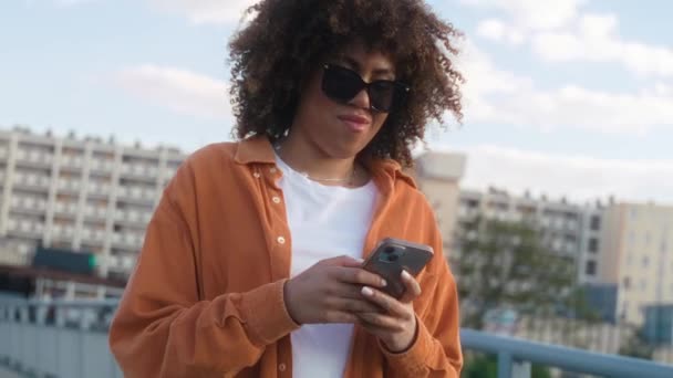 Черная Женщина Переходит Мост Смотрит Свой Мобильный Телефон Съемка Красной — стоковое видео