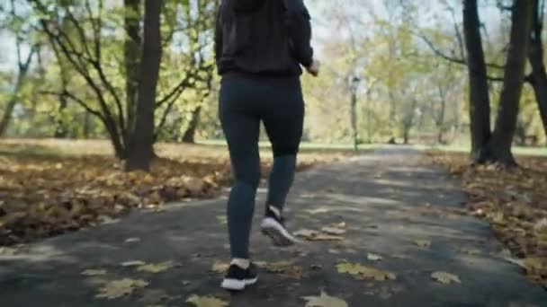 Handheld Low Section Woman Legs Jogging Park Shot Red Helium — Stock Video