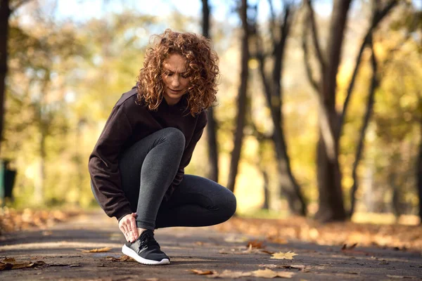 Woman Squatting Feeling Ankle Injury Jogging Park — Stock Photo, Image