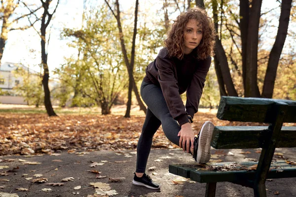 Full Length Ginger Woman Stretching Bench Jogging Park — Stock Photo, Image