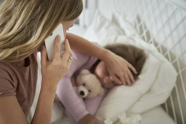 Mother Calling Doctor While Her Daughter Lying Ill Bed — Stock Photo, Image