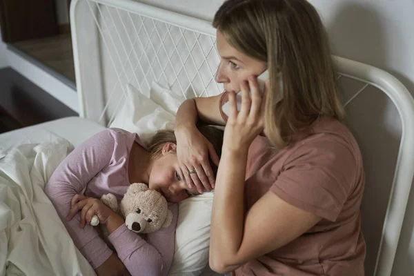 Mother Calling Doctor While Her Daughter Lying Ill Bed — Stock Photo, Image