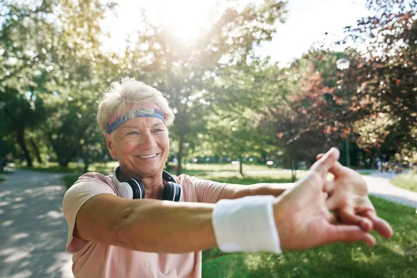 Senior woman exercising in the park in the summer