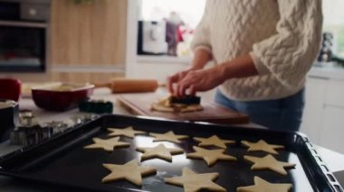 Tanınmayan bir kadın hamurdan zencefilli kurabiye kesiyor. 8K 'da kırmızı helyum kamerayla çekildi.. 