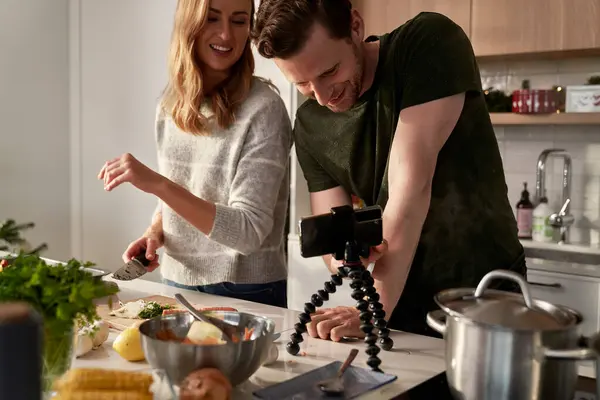 Caucasian couple preparing food before Christmas and recording video