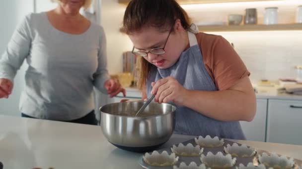 ダウン症の女性と母親は自家製のカップケーキを作っています 8KでRedヘリウムカメラで撮影する — ストック動画