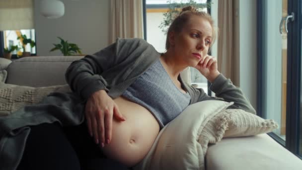 Anxious Pregnant Woman Lying Sofa Touching Her Abdomen — Stock Video