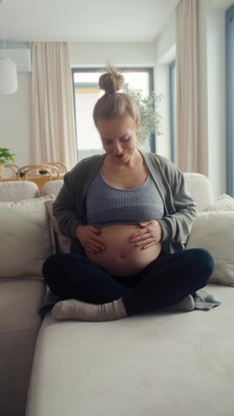 Vertical Video Caucasian Pregnant Woman Sitting Sofa Touching Her Abdomen — Stock Video