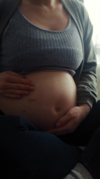 Vertical Video Unrecognizable Caucasian Pregnant Woman Sitting Sofa Touching Her — Stock Video