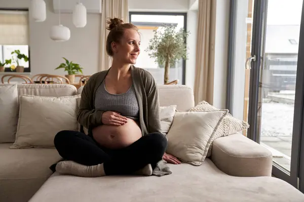 Caucásica Embarazada Sentada Sofá Tocando Abdomen —  Fotos de Stock