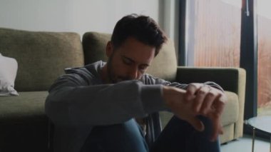Düşünceli ve endişeli bir adam cep telefonunu kontrol ediyor. 