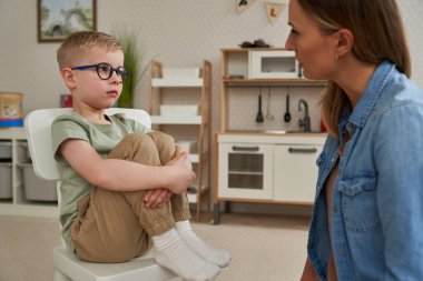 Little boy and the therapist  clipart